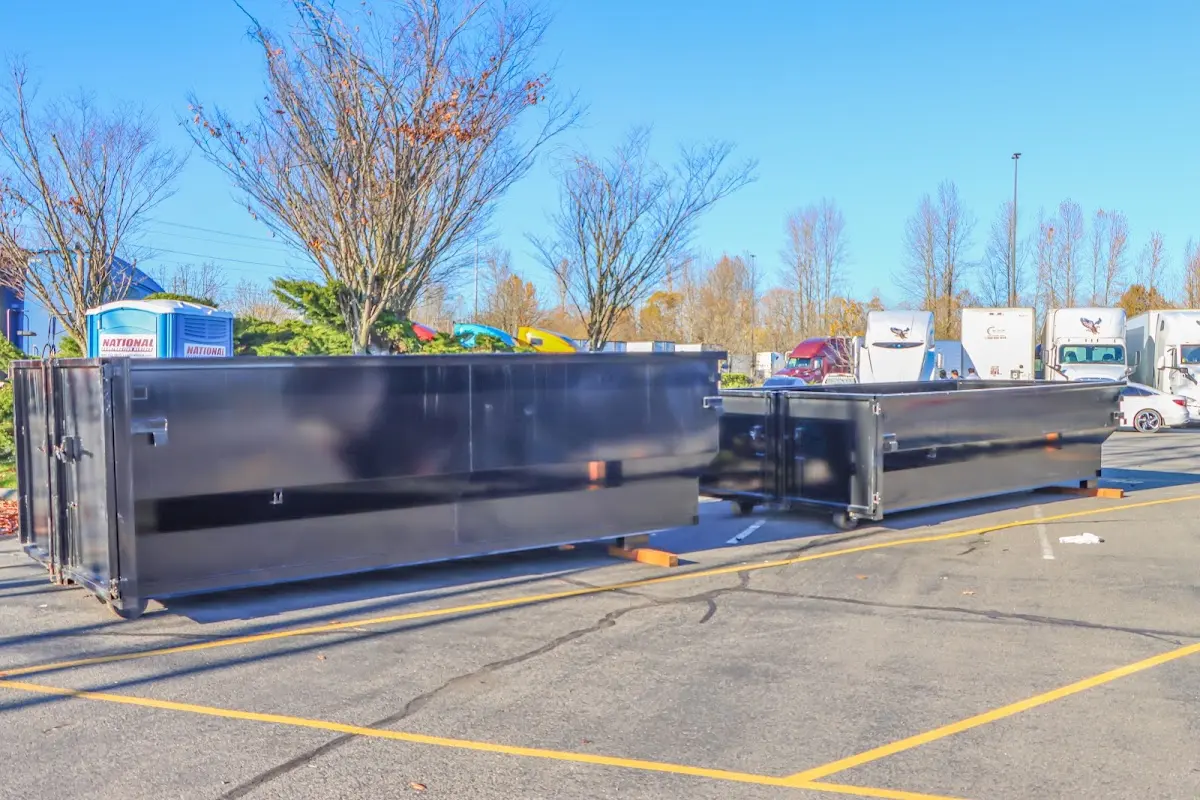 Professional dumpster rental service with roll-off container on residential driveway in East Hartford